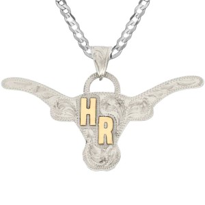 A custom pendant necklace built on a hand engraved silver base in the shape of a longhorn featuring bronze initials, with a sterling silver chain 